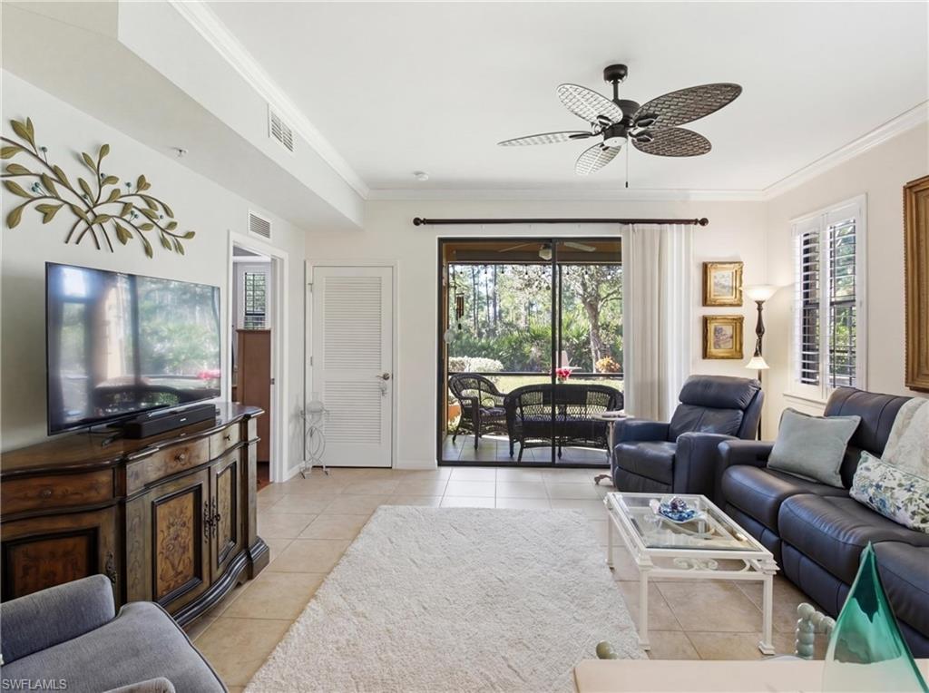 20161 Bravada Street, Unit 2 Estero, FL 33928 - Photo 6 of 33 a living room with furniture and a flat screen tv with wooden floor