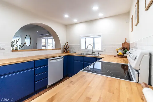 a kitchen with stainless steel appliances a sink and a large window