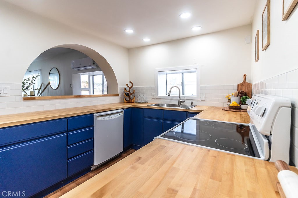 503 Palm Way Needles, CA 92363 - Photo 16 of 50 a kitchen with stainless steel appliances a sink and a large window