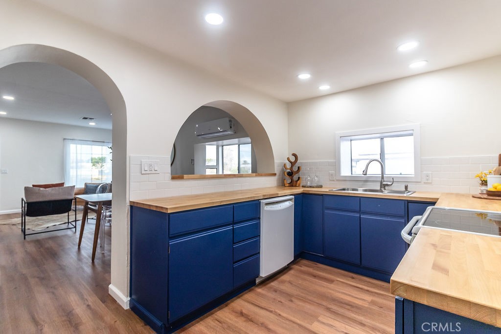 503 Palm Way Needles, CA 92363 - Photo 18 of 50 a kitchen with granite countertop a sink and wooden cabinets
