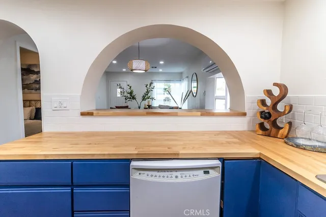 a view of a kitchen with a sink and wooden floor
