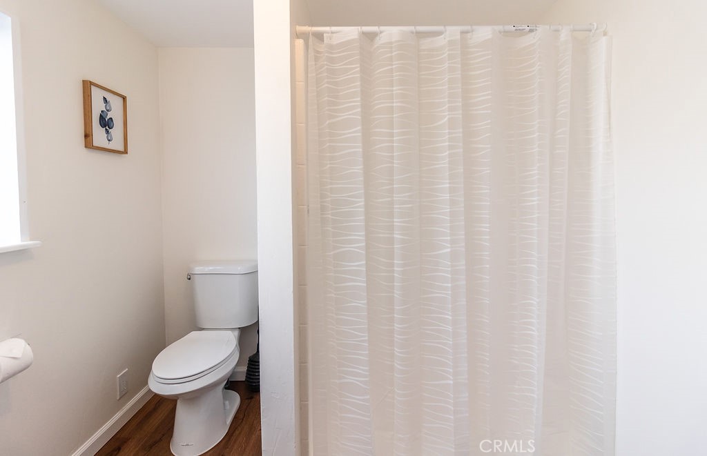 503 Palm Way Needles, CA 92363 - Photo 25 of 50 a white toilet sitting next to a white curtain