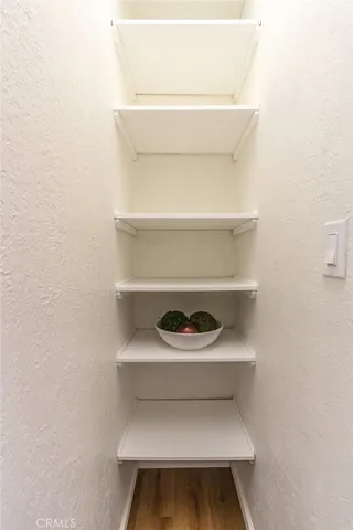 a bedroom with bed and wooden floor