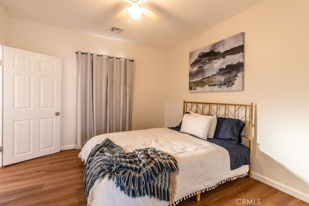 503 Palm Way Needles, CA 92363 - Photo 33 of 50 a bedroom with bed and wooden floor