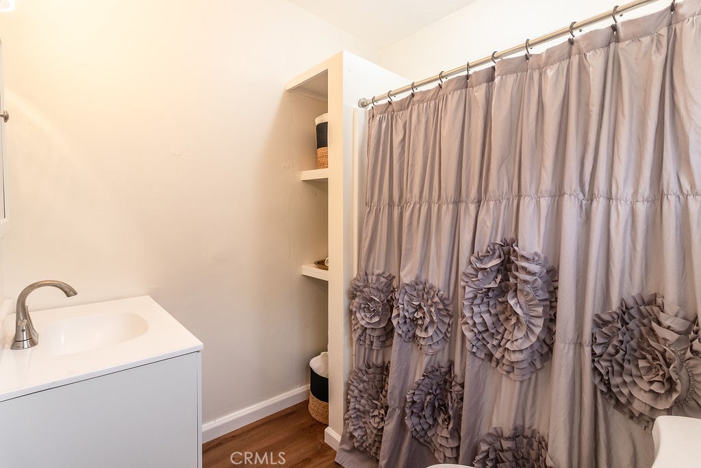 503 Palm Way Needles, CA 92363 - Photo 37 of 50 a bathroom with a shower curtain and a sink
