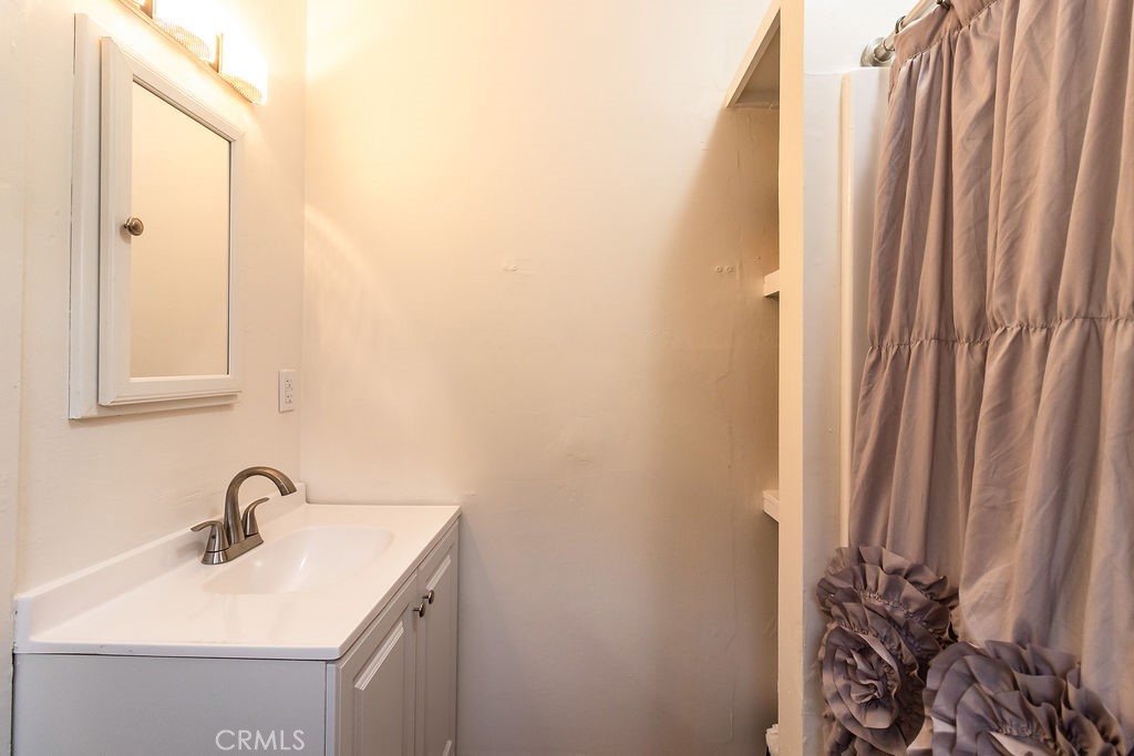 503 Palm Way Needles, CA 92363 - Photo 38 of 50 a bathroom with a sink a mirror and a shower