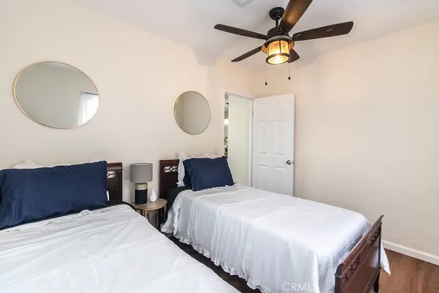 a bedroom with bed and a chandelier