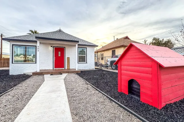 a front view of a house with parking space