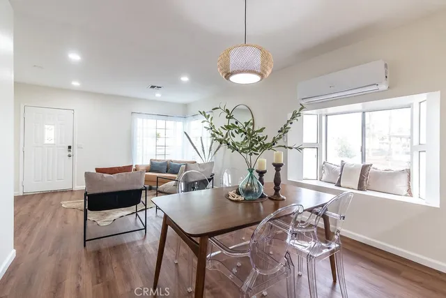 a dining room with furniture and wooden floor