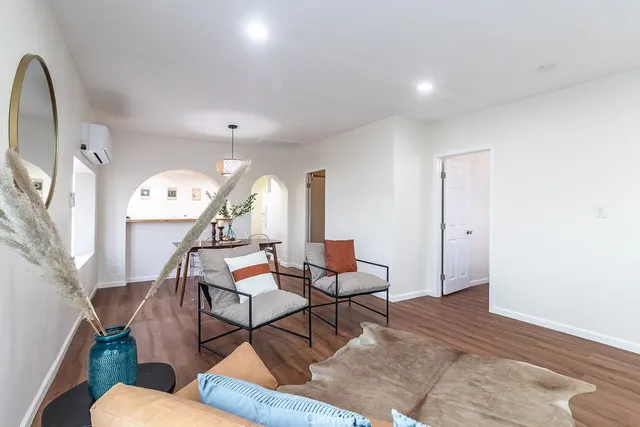 a living room with furniture and a chandelier