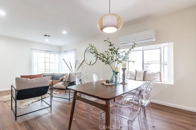 a view of a dining room with furniture window and wooden floor