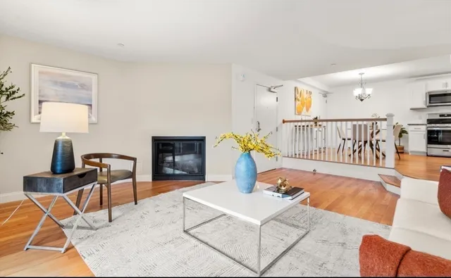 a living room with furniture a rug and a table