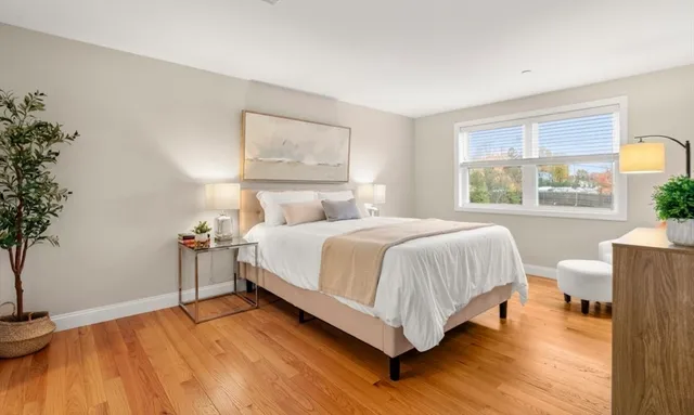 a bedroom with a bed and a potted plant