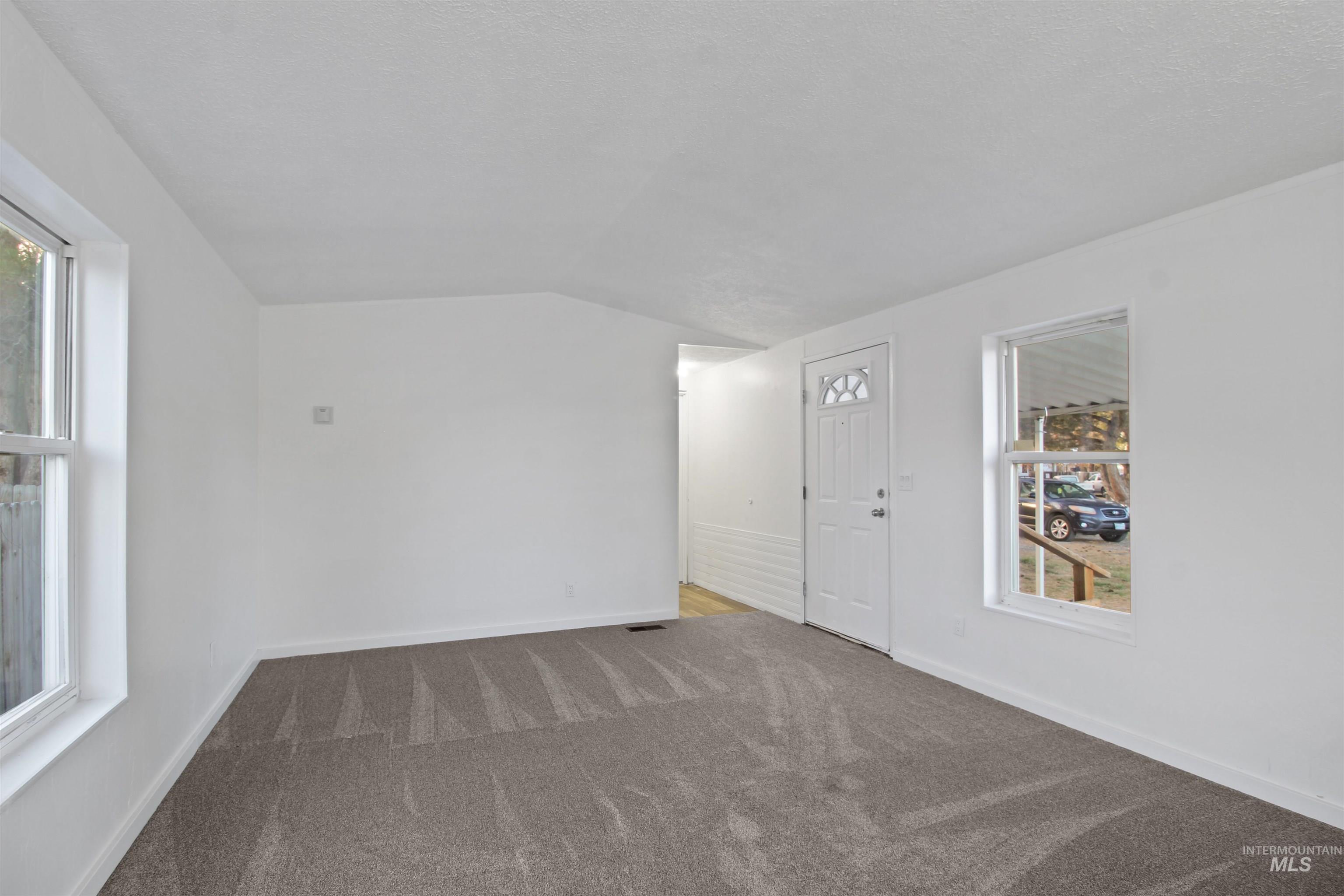 377 South 200 West, Unit 36 Rupert, ID 83350 - Photo 24 of 31 Unfurnished room with carpet floors and lofted ceiling