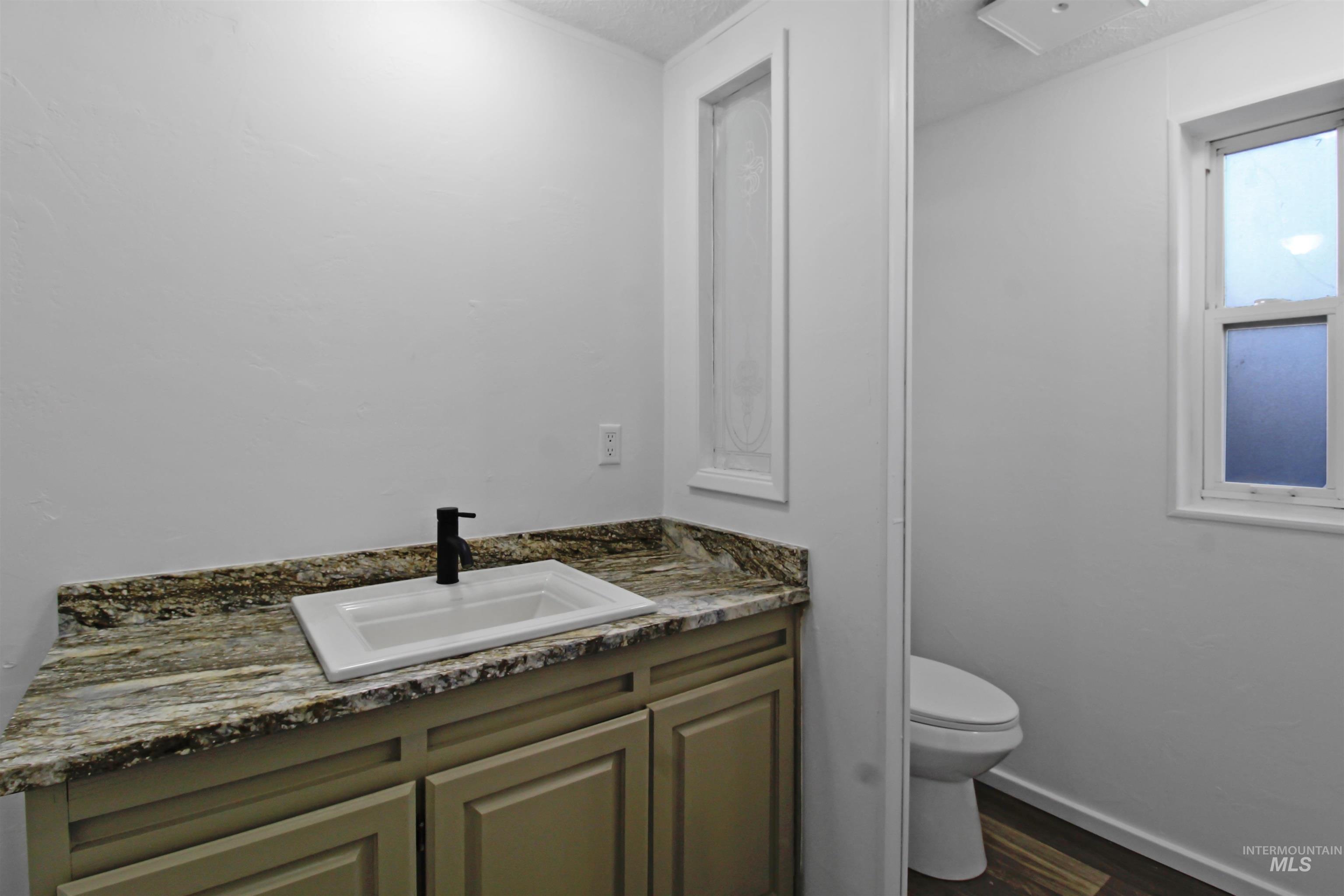 377 South 200 West, Unit 36 Rupert, ID 83350 - Photo 4 of 31 Bathroom featuring vanity and dark wood-style floors