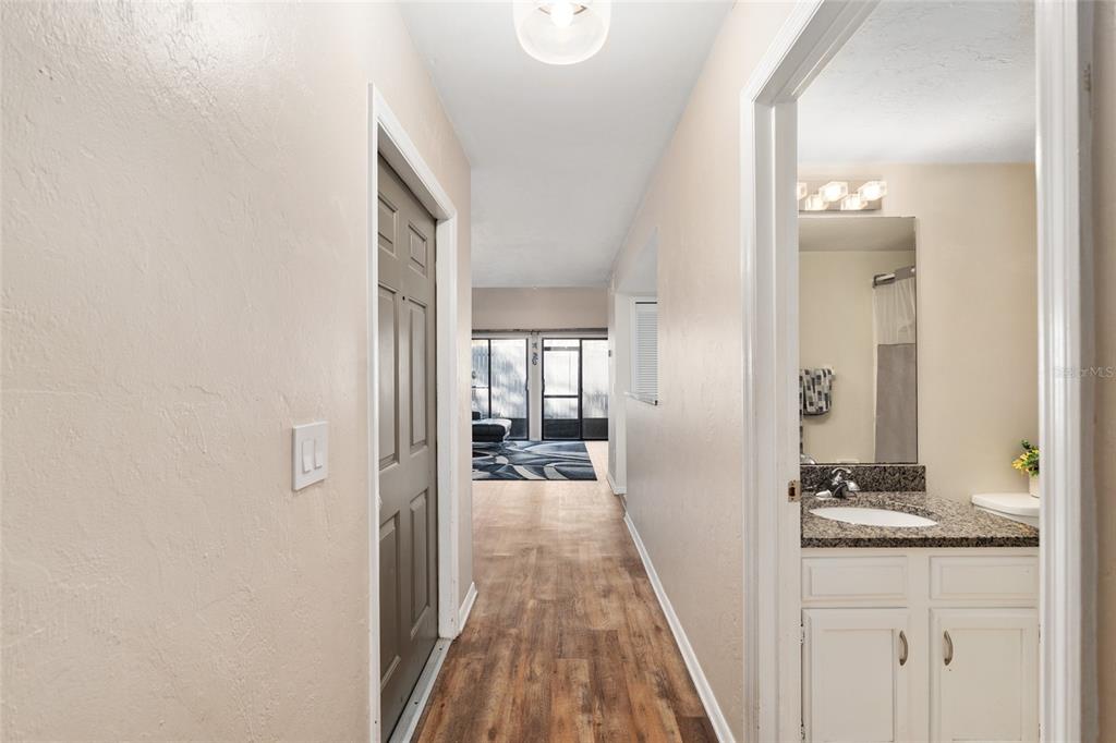7200 Southwest 8th Avenue, Unit E29 Gainesville, FL 32607 - Photo 11 of 47 a view of a hallway with wooden floor and a bathroom