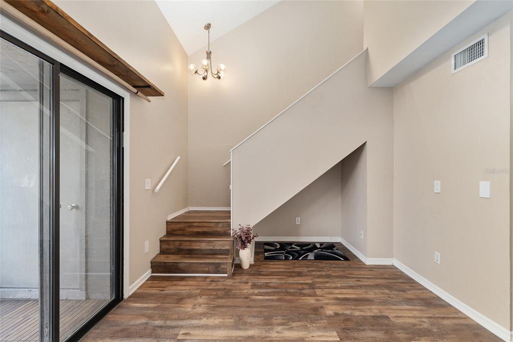 7200 Southwest 8th Avenue, Unit E29 Gainesville, FL 32607 - Photo 19 of 47 a view of entryway and hall with wooden floor