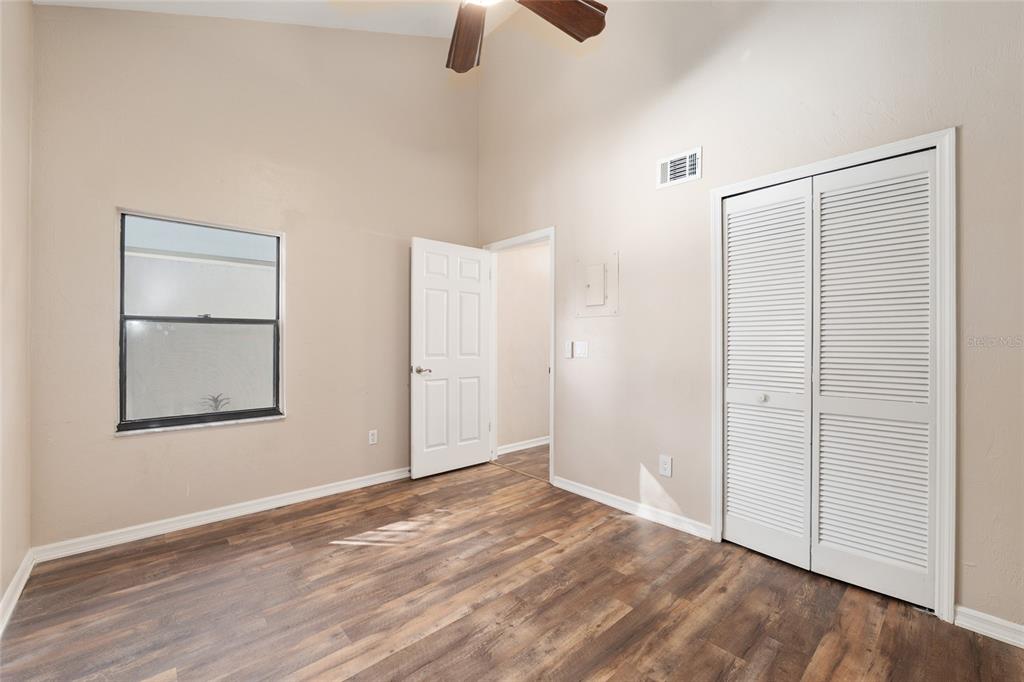 7200 Southwest 8th Avenue, Unit E29 Gainesville, FL 32607 - Photo 28 of 47 an empty room with ceiling fan and window