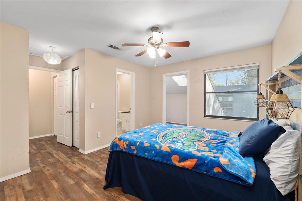 7200 Southwest 8th Avenue, Unit E29 Gainesville, FL 32607 - Photo 34 of 47 a bedroom that has a bed and a chandelier