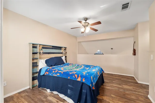 a bedroom with a bed and a chandelier