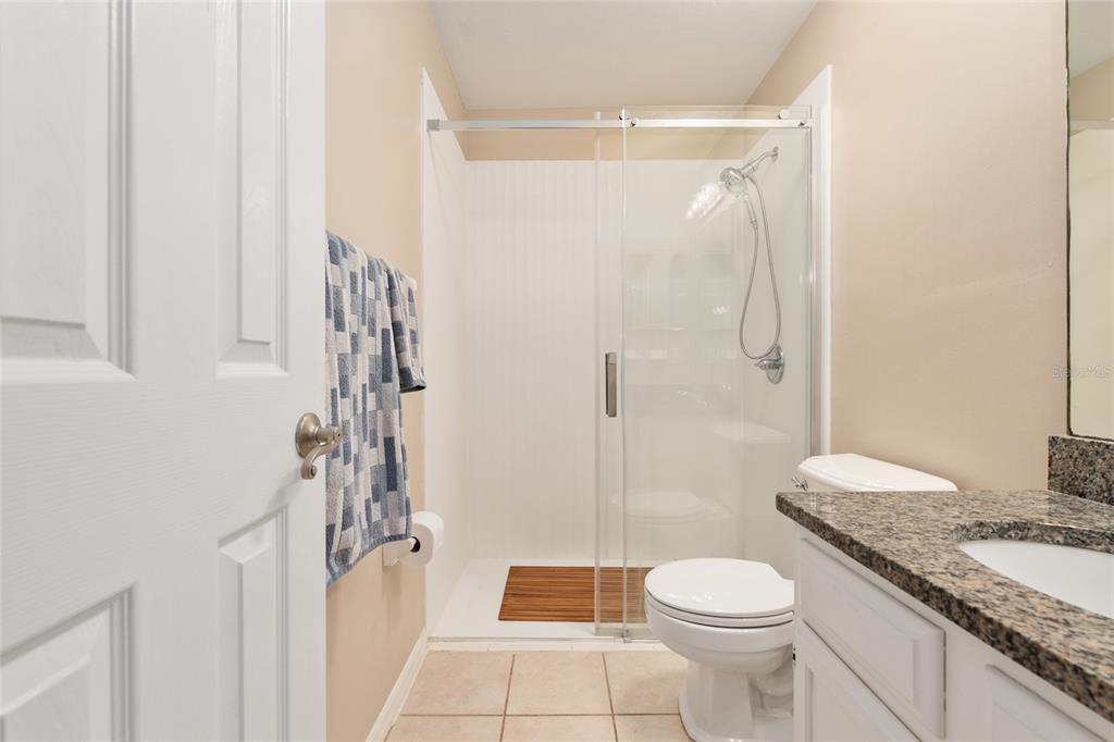 7200 Southwest 8th Avenue, Unit E29 Gainesville, FL 32607 - Photo 36 of 47 a bathroom with a granite countertop sink toilet and shower