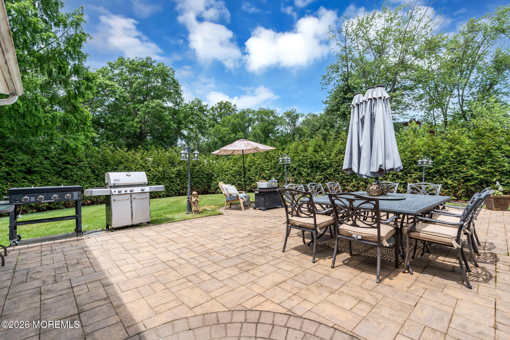 8 Owens Road Marlboro, NJ 07746 - Photo 35 of 39 a view of a backyard with furniture and a garden