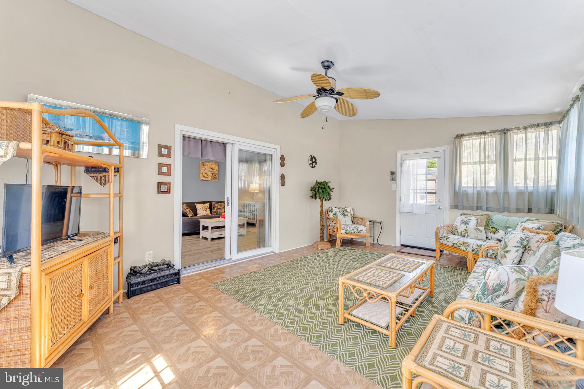 4 Barbara Place Somerdale, NJ 08083 - Photo 18 of 36 a living room with furniture a flat screen tv and a chandelier