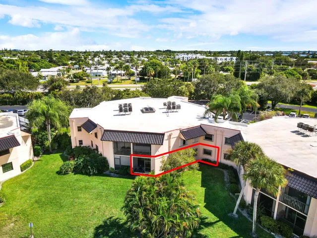 a view of a house with a big yard plants and large trees
