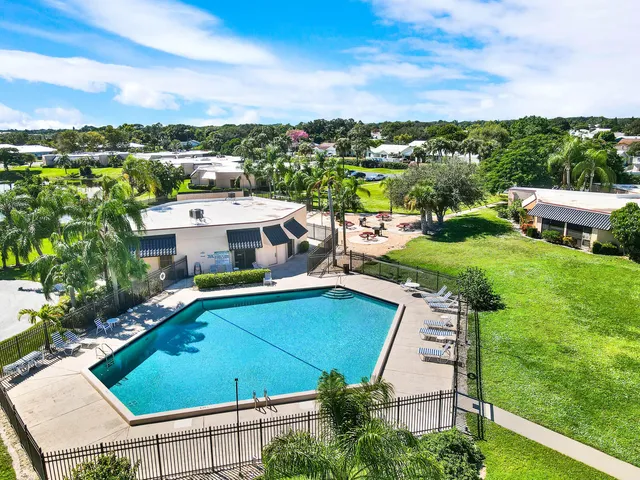 a view of a swimming pool with outdoor seating