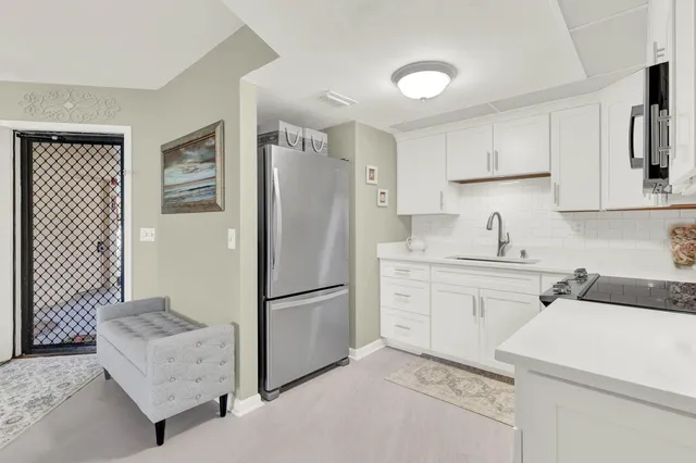 a kitchen with a refrigerator sink and stove