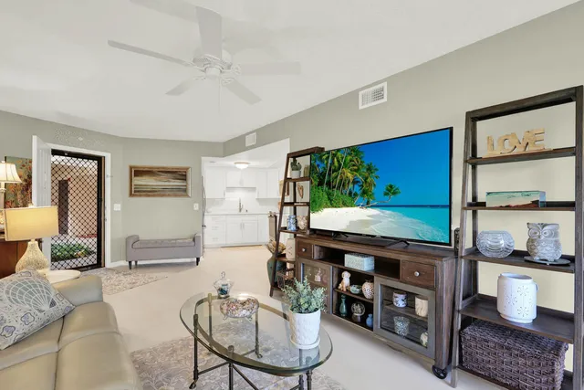 a living room with furniture and a floor to ceiling window
