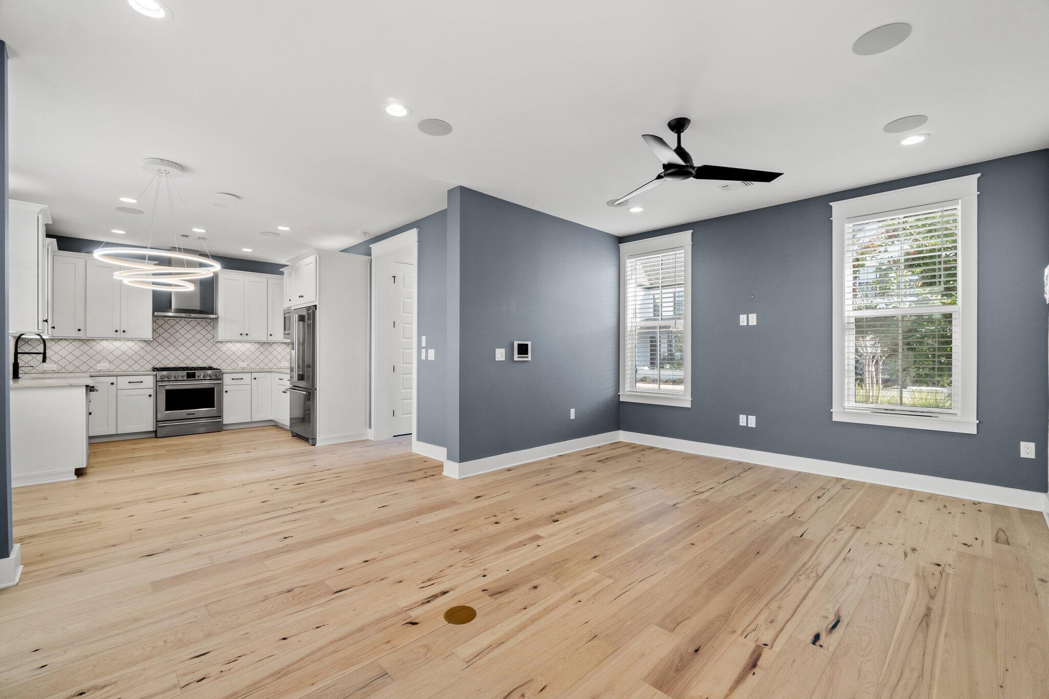 414 Ridgewalk Circle Santa Rosa Beach, FL 32459 - Photo 11 of 43 a large kitchen with stainless steel appliances kitchen island granite countertop a refrigerator oven a stove and a sink with wooden floor