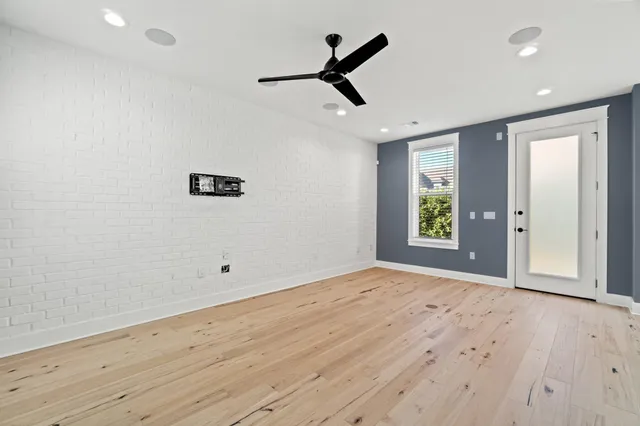wooden floor in an empty room with a window