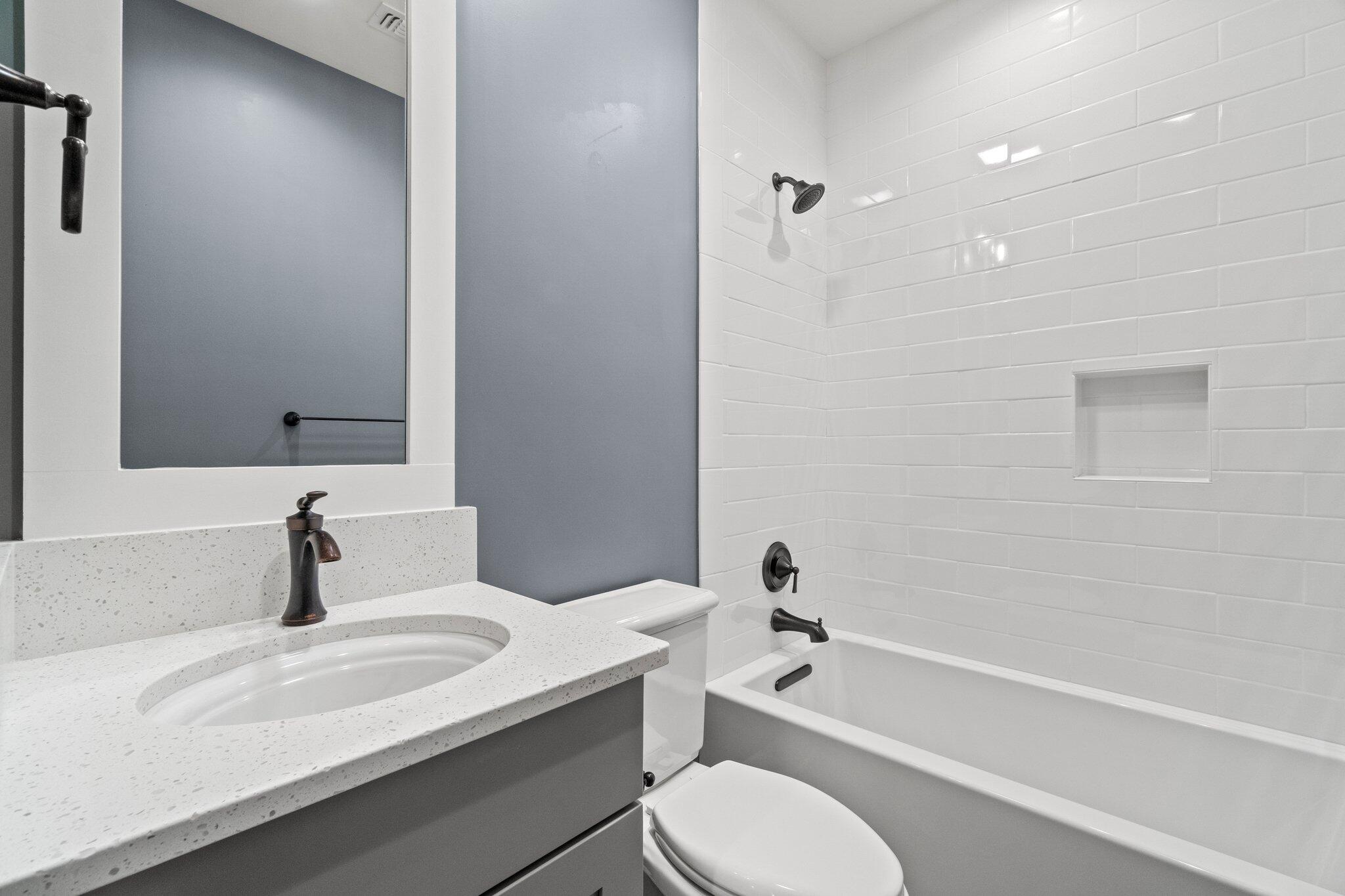414 Ridgewalk Circle Santa Rosa Beach, FL 32459 - Photo 16 of 43 a bathroom with a granite countertop sink toilet a mirror and bathtub