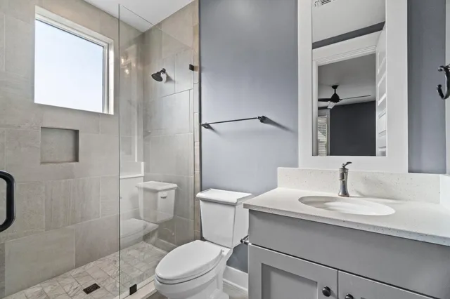 a bathroom with a sink toilet and shower