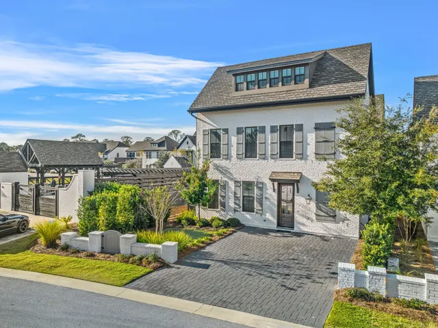 a view of a building with a garden and pathway