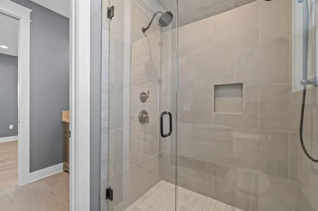 a bathroom with a glass shower door