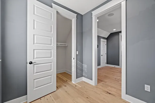 a view of a hallway with wooden floor