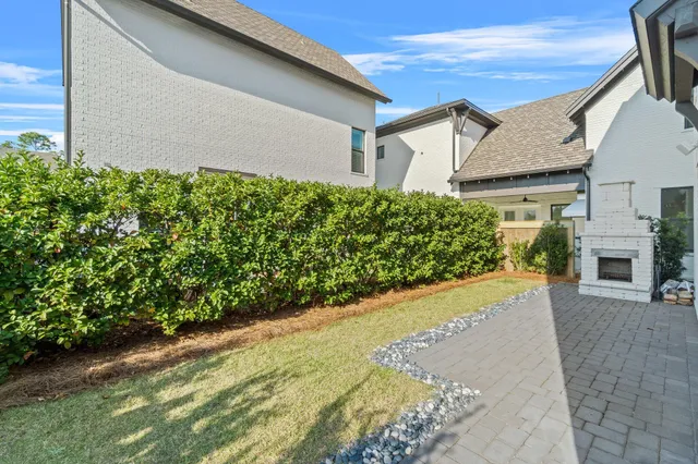 a view of a house with a yard and potted plants
