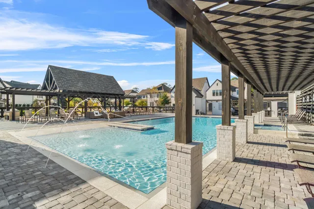 a view of a patio with a table chairs potted plants and palm trees