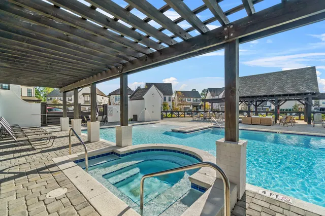 a swimming pool with outdoor seating and yard
