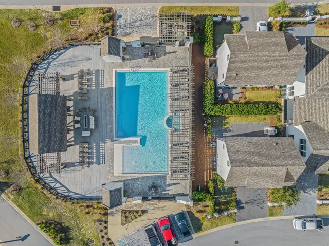 an aerial view of residential houses with outdoor space and swimming pool