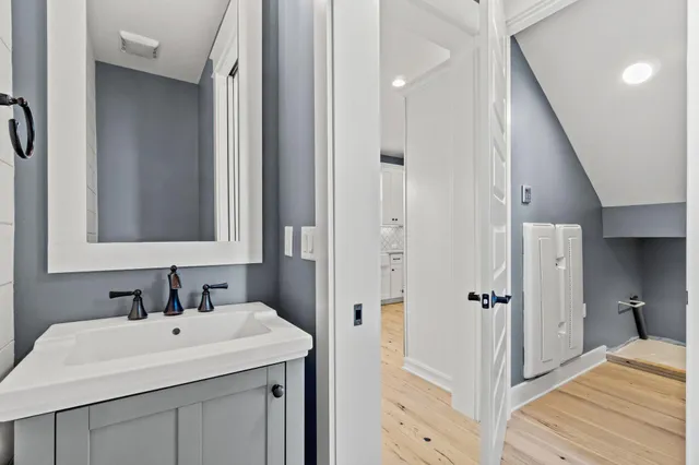 a bathroom with a sink a mirror and a shower