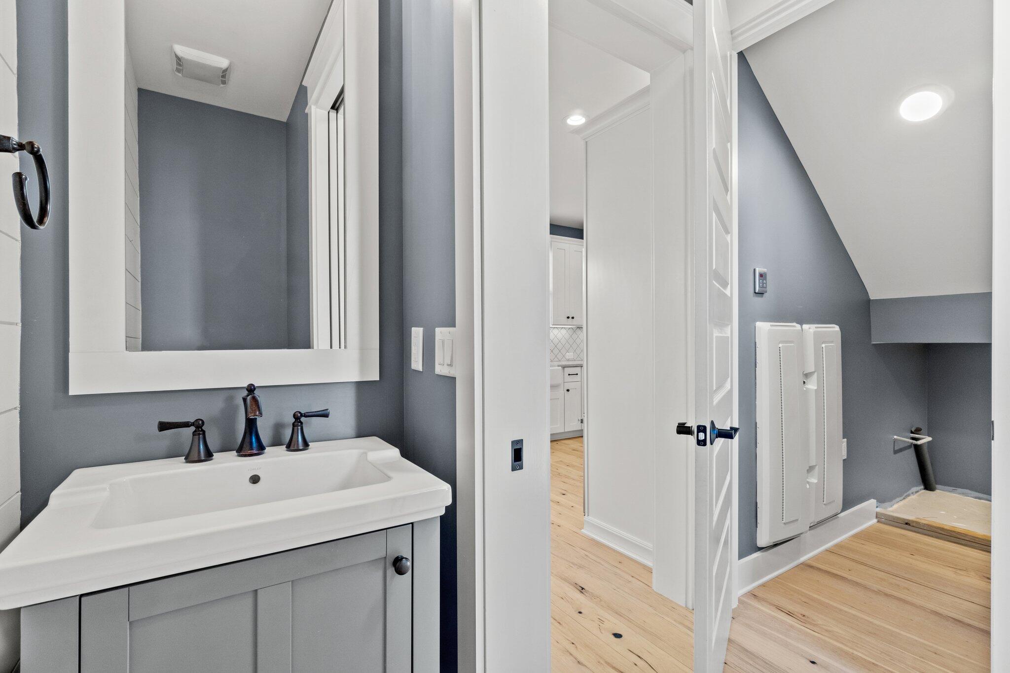 414 Ridgewalk Circle Santa Rosa Beach, FL 32459 - Photo 5 of 43 a bathroom with a sink a mirror and a shower