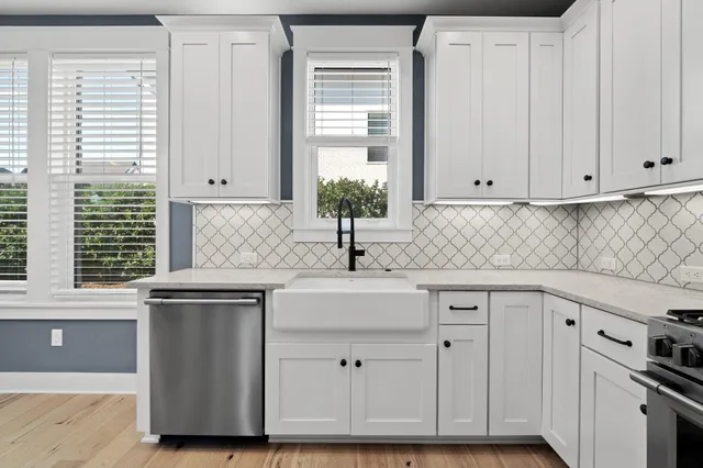 a kitchen with stainless steel appliances granite countertop a sink and a cabinets