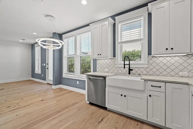 a kitchen with a window a sink and cabinets
