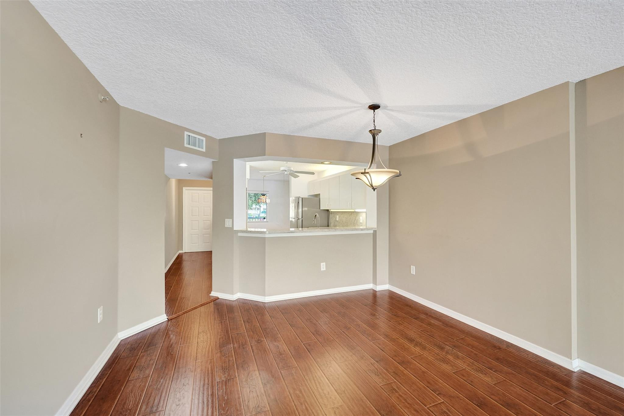 9563 Weldon Circle, Unit D212 Tamarac, FL 33321 - Photo 20 of 69 a view of a room with wooden floor and windows