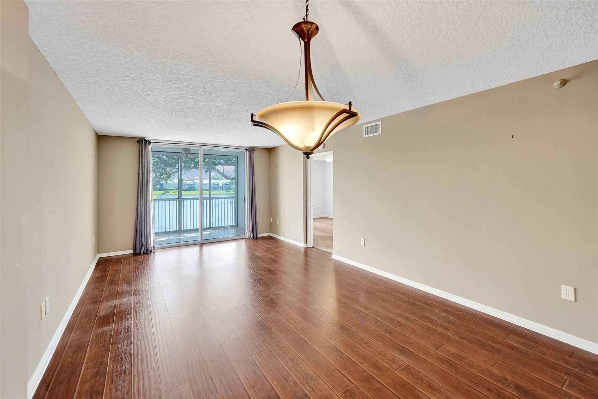 9563 Weldon Circle, Unit D212 Tamarac, FL 33321 - Photo 23 of 69 a view of a room with wooden floor fan and a window