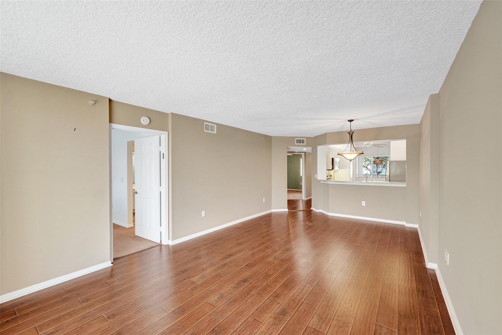 9563 Weldon Circle, Unit D212 Tamarac, FL 33321 - Photo 25 of 69 a view of an empty room with wooden floor