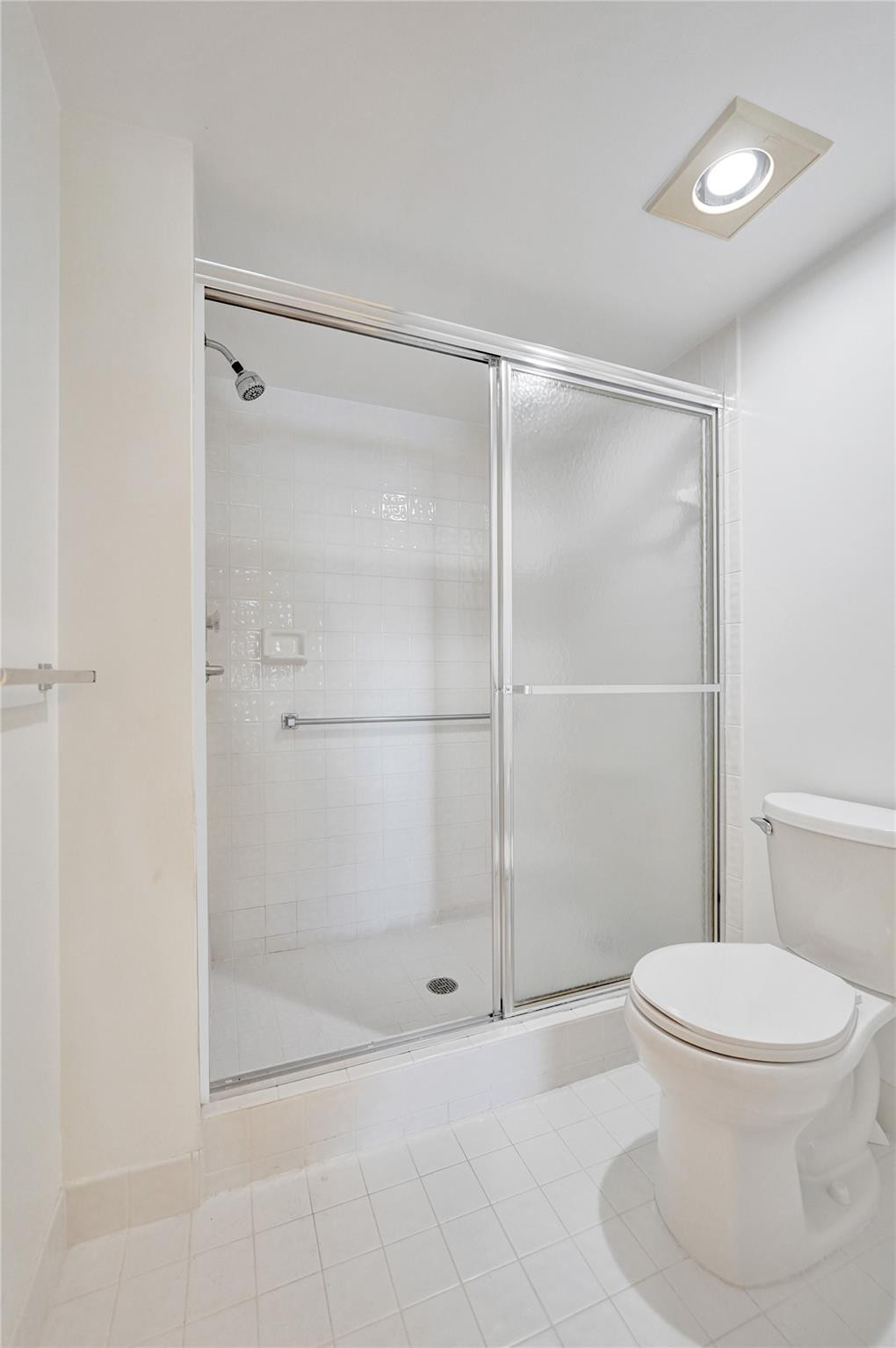 9563 Weldon Circle, Unit D212 Tamarac, FL 33321 - Photo 37 of 69 a bathroom with a toilet and a shower